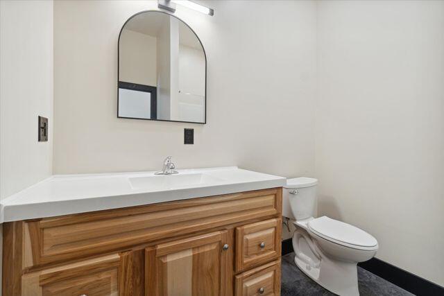 bathroom featuring vanity and toilet