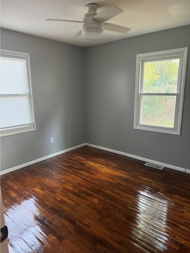 unfurnished room featuring ceiling fan and dark hardwood / wood-style flooring