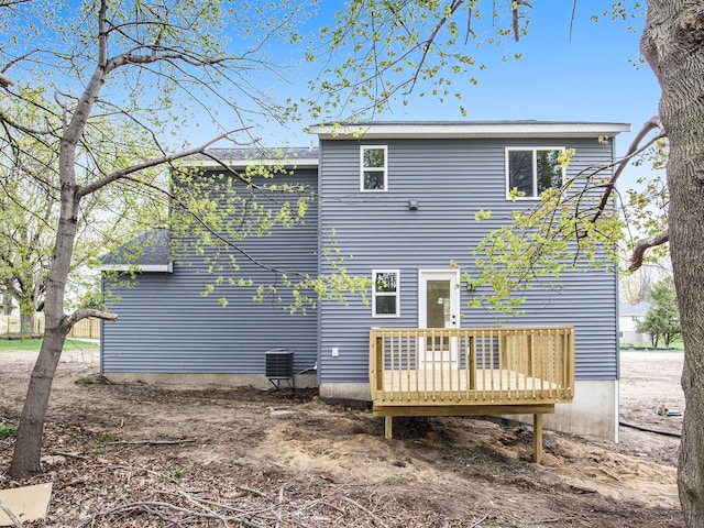 back of property with central air condition unit and a deck