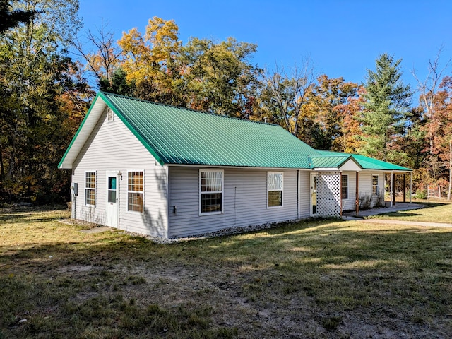 view of side of home featuring a yard