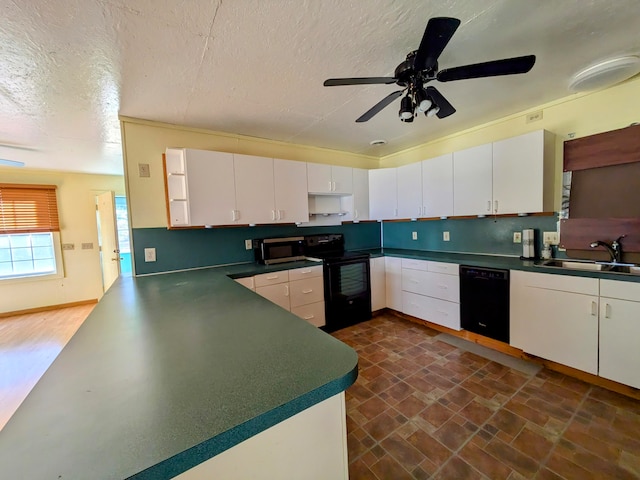 kitchen with a textured ceiling, black appliances, sink, and white cabinets