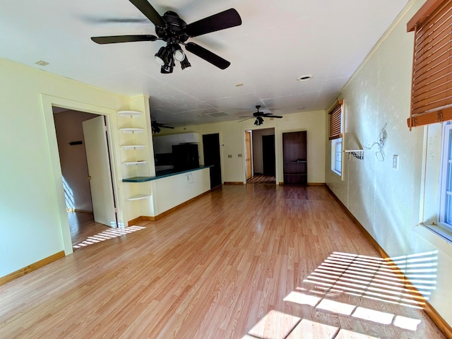 unfurnished living room featuring light hardwood / wood-style floors and plenty of natural light