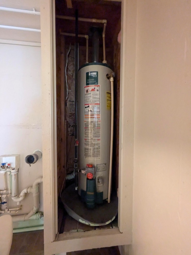 utility room featuring gas water heater