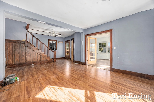 interior space featuring wood-type flooring and ceiling fan