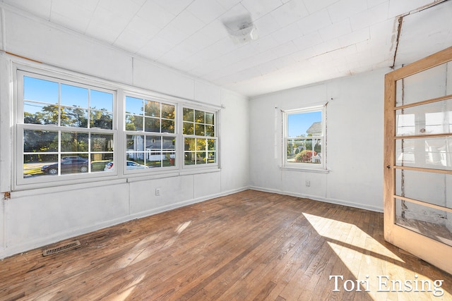 spare room with hardwood / wood-style floors