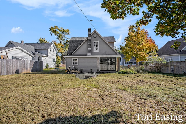 back of house featuring a patio and a lawn