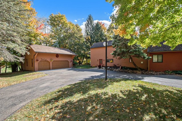 view of side of property with a yard and a garage