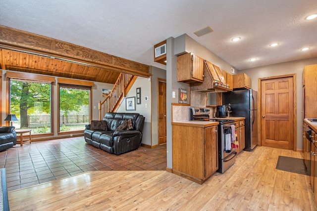 kitchen with decorative backsplash, beam ceiling, range hood, light wood-type flooring, and appliances with stainless steel finishes