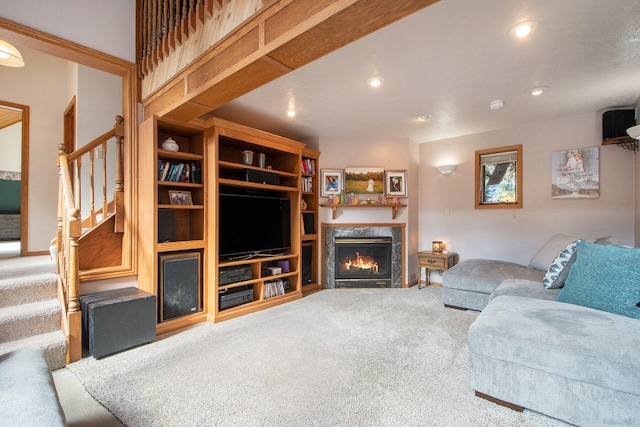 carpeted living room with a high end fireplace