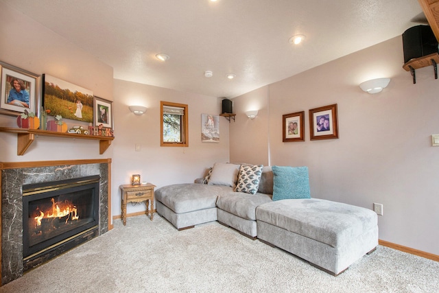 carpeted living room featuring a premium fireplace