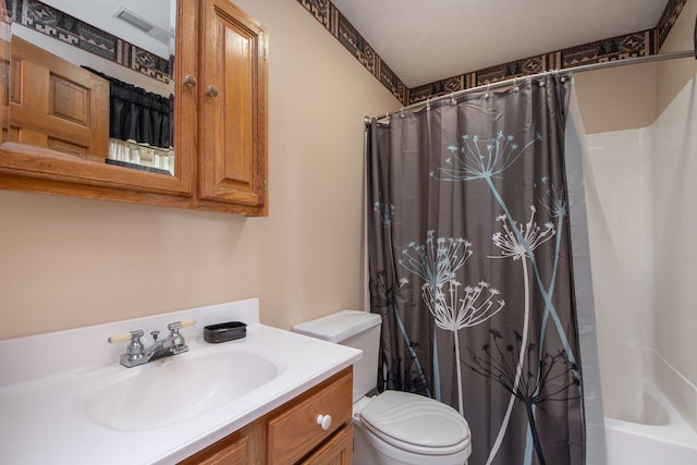 full bathroom with vanity, a textured ceiling, shower / tub combo with curtain, and toilet