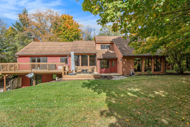 back of house featuring a yard and a wooden deck