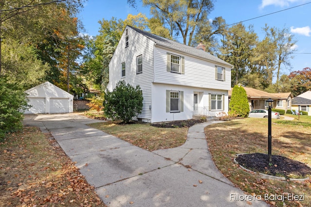 view of front of house featuring a front yard, an outdoor structure, and a garage