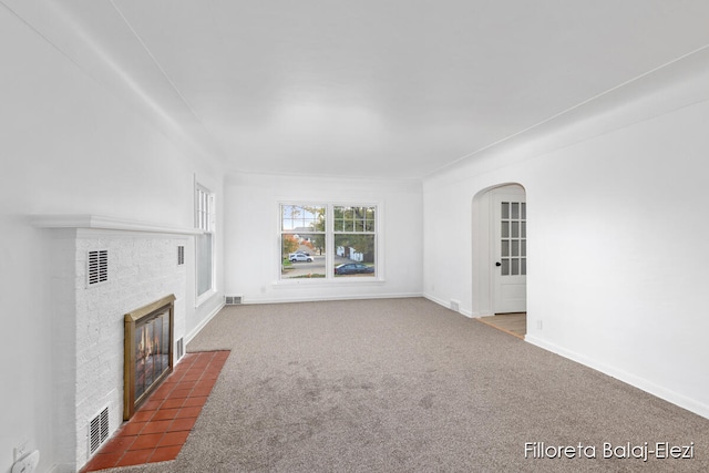 unfurnished living room featuring carpet and a fireplace