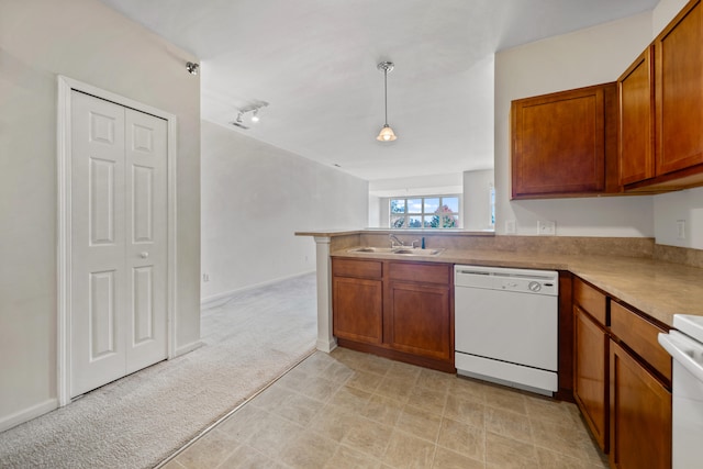 kitchen with white appliances, sink, kitchen peninsula, pendant lighting, and light colored carpet