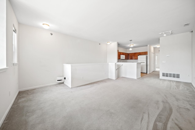 unfurnished living room featuring light colored carpet