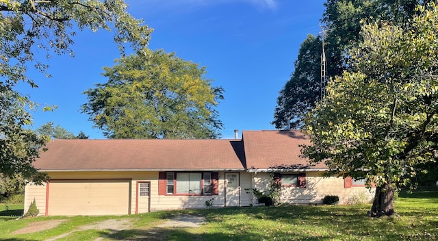 single story home with a front yard and a garage