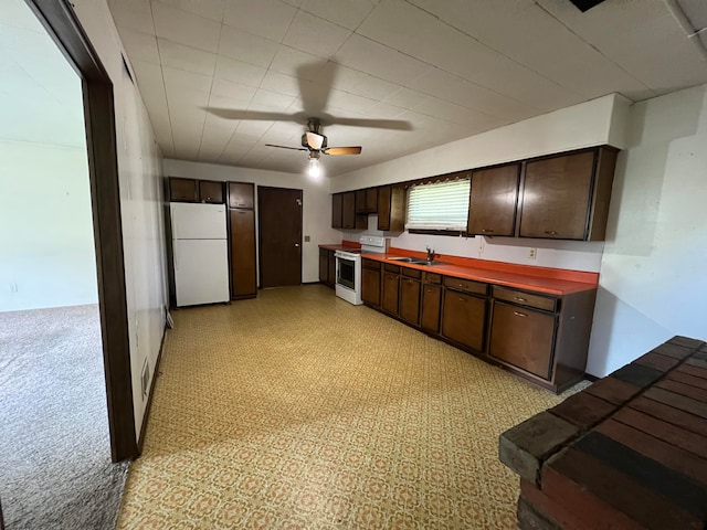 kitchen with ceiling fan, sink, dark brown cabinets, and white appliances