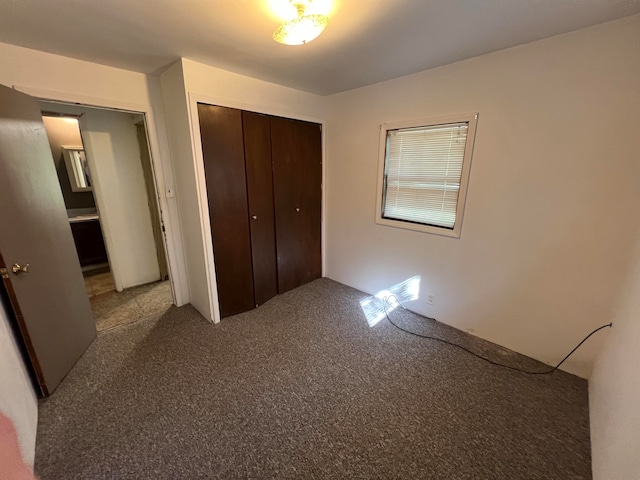 unfurnished bedroom featuring a closet and carpet