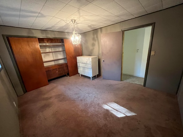 interior space with an inviting chandelier, light carpet, and a closet