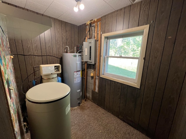 utility room featuring electric panel and electric water heater