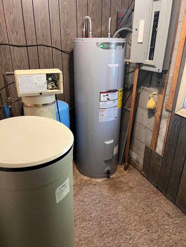 utility room featuring electric panel and water heater