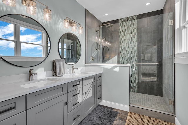 bathroom featuring a shower with door, hardwood / wood-style floors, and vanity