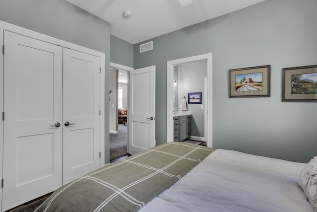 carpeted bedroom featuring a closet and connected bathroom