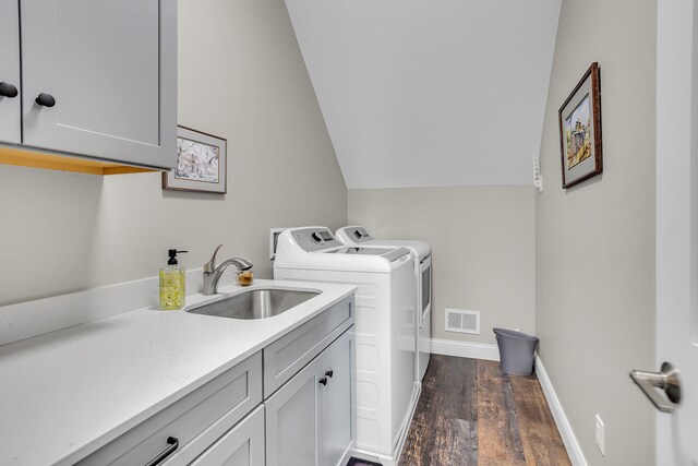 washroom with cabinets, dark hardwood / wood-style floors, sink, and separate washer and dryer