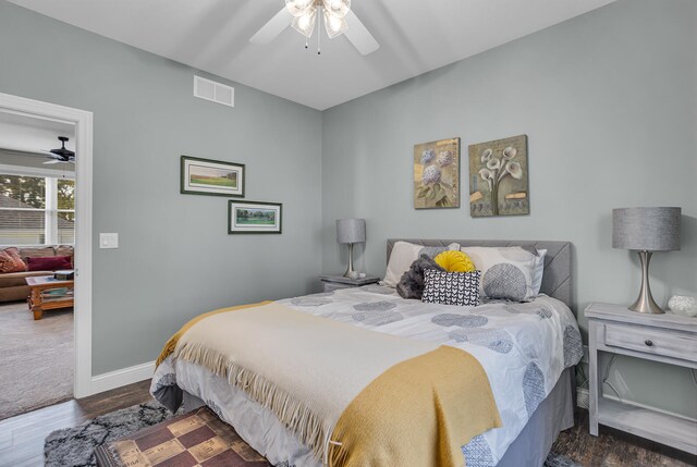 bedroom with ceiling fan and dark hardwood / wood-style flooring