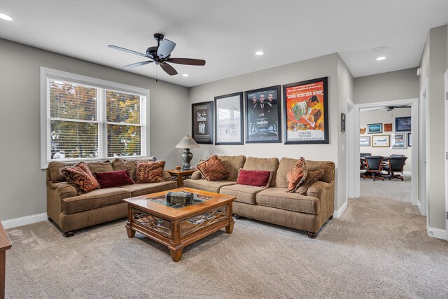 carpeted living room with ceiling fan