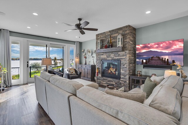 living room featuring a fireplace, hardwood / wood-style flooring, and ceiling fan