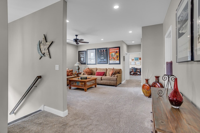 carpeted living room with ceiling fan