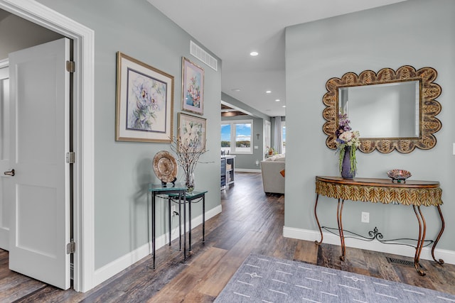 hallway with dark hardwood / wood-style flooring