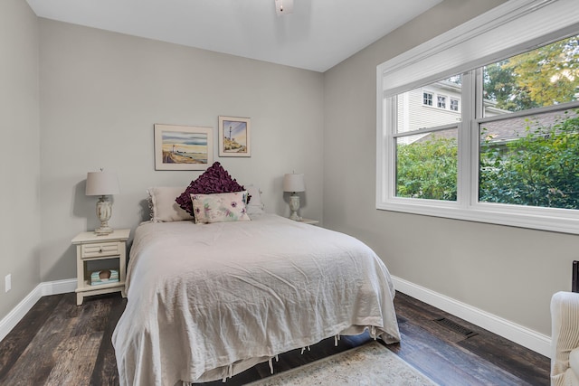 bedroom with dark hardwood / wood-style flooring