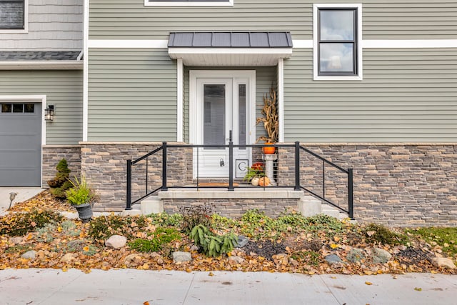 view of exterior entry with a garage