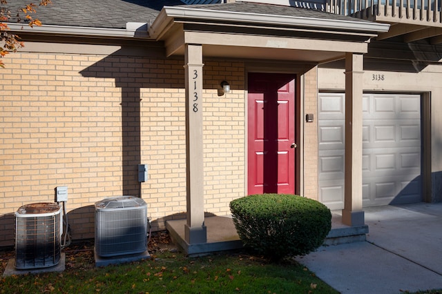 doorway to property featuring central AC and a garage