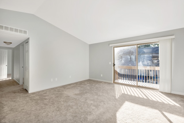 carpeted empty room with lofted ceiling