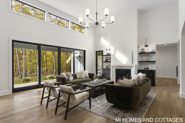 living room featuring a high ceiling, hardwood / wood-style flooring, and plenty of natural light