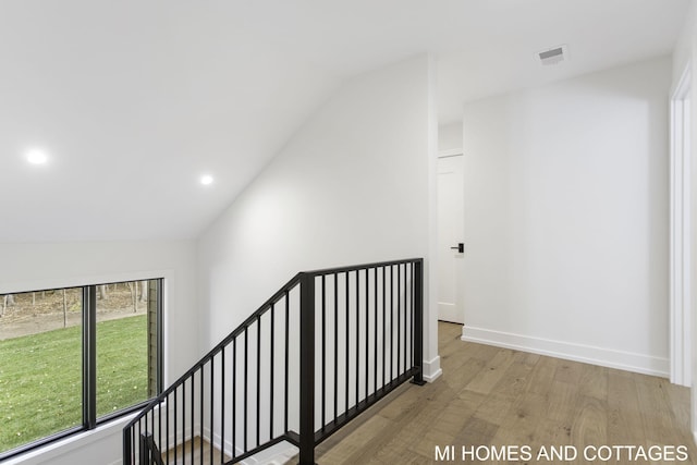 interior space featuring lofted ceiling and light wood-type flooring