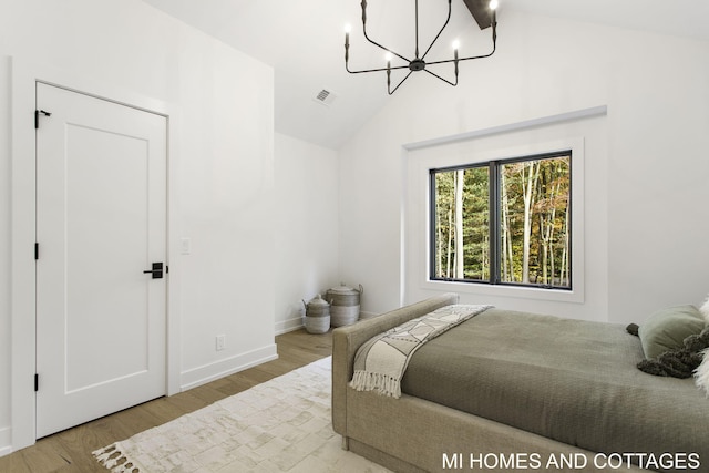 bedroom featuring a notable chandelier, hardwood / wood-style flooring, beamed ceiling, and high vaulted ceiling