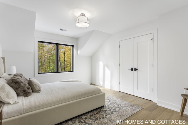 bedroom with a closet and light hardwood / wood-style floors