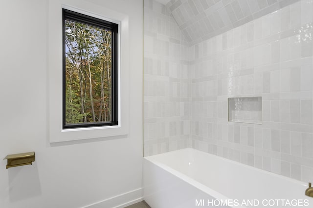 bathroom featuring vaulted ceiling