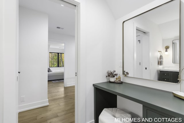 bathroom featuring vanity and hardwood / wood-style floors