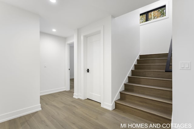 staircase with wood-type flooring