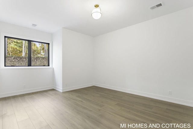 empty room with hardwood / wood-style floors