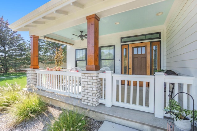 entrance to property with a ceiling fan and covered porch