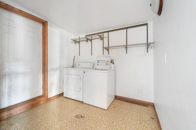 clothes washing area with washing machine and dryer