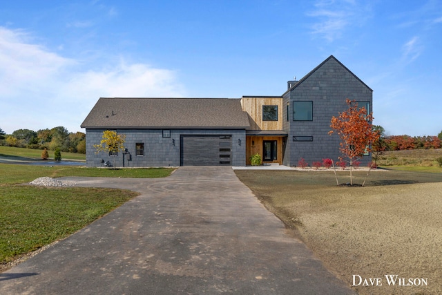 view of front of property featuring a garage and a front yard