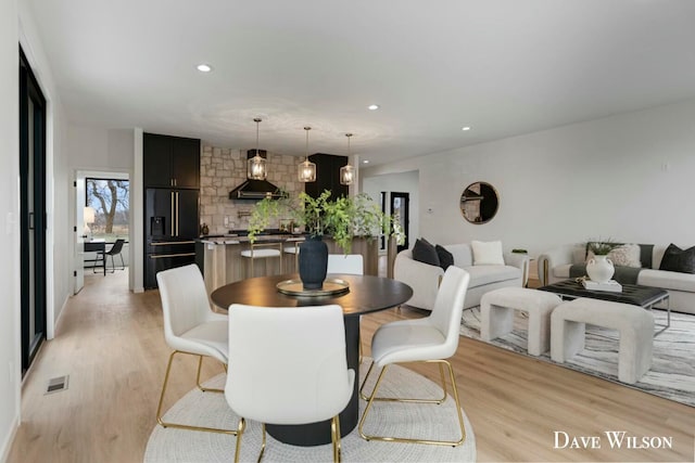 dining space with light hardwood / wood-style flooring